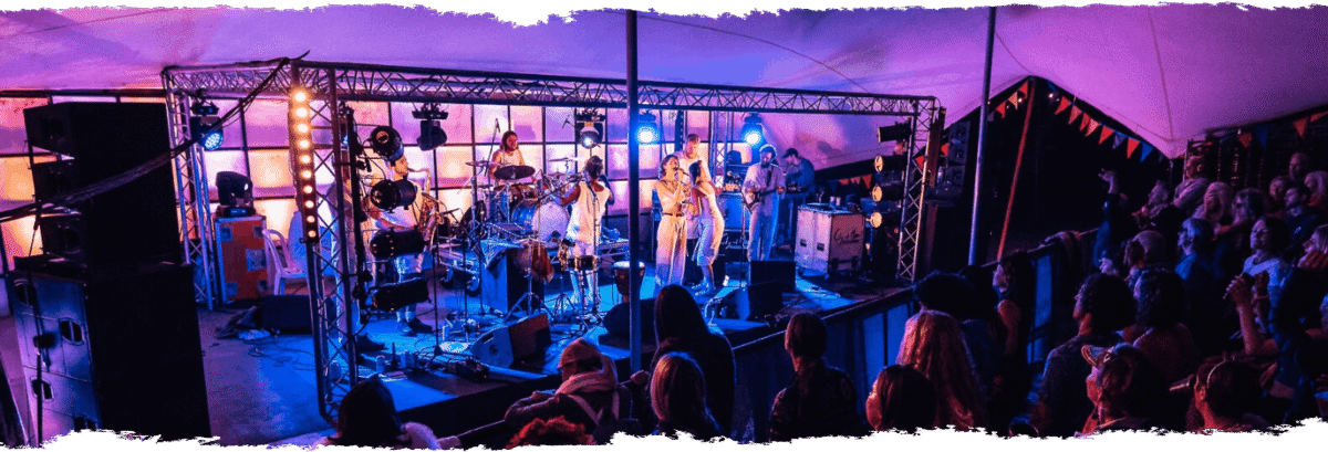 Purple lighting on stage with performers